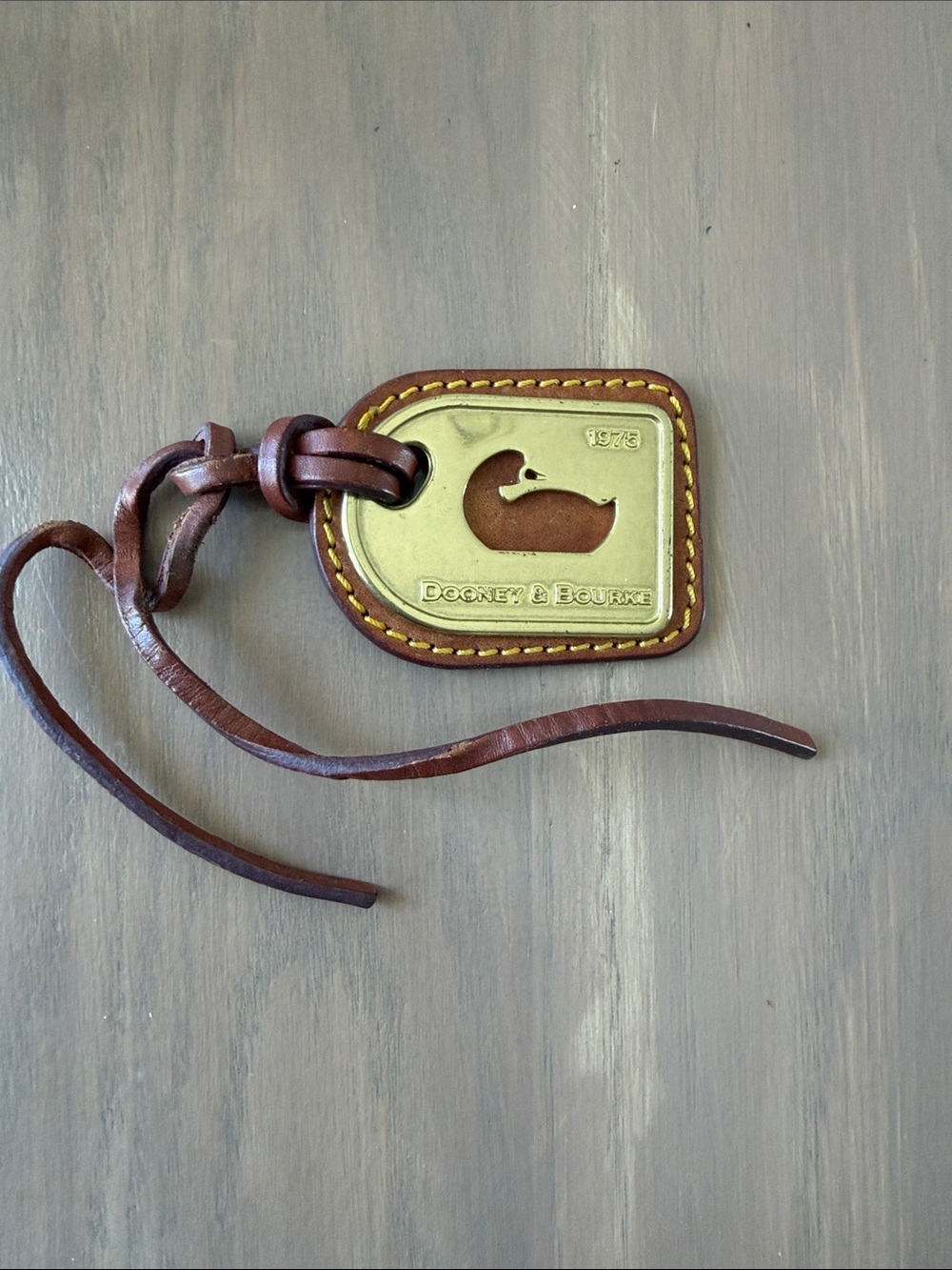 Dooney & Bourke Brown Leather & Gold  1975 Duck Tag